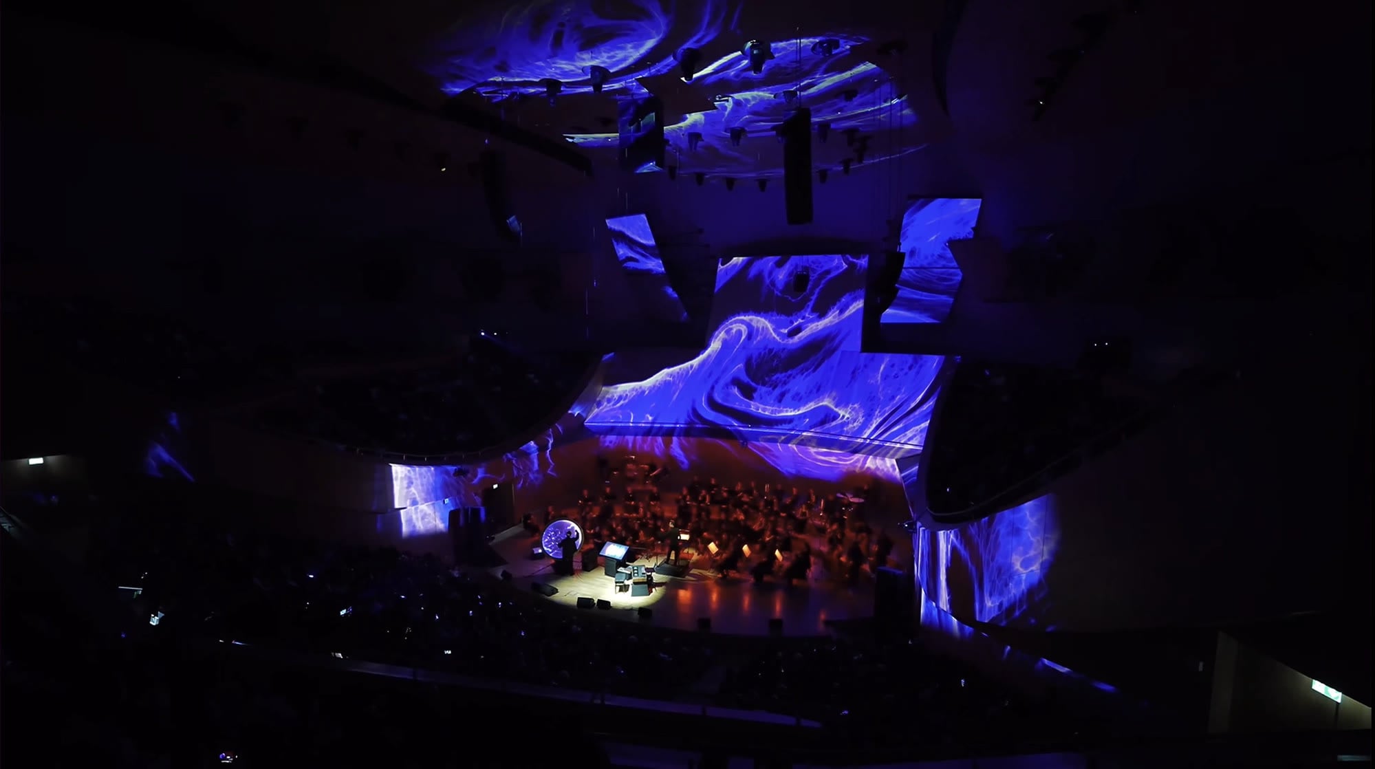 Cosmic Symphony orchestra surrounded by blue projection mapping at CSO Concert Hall